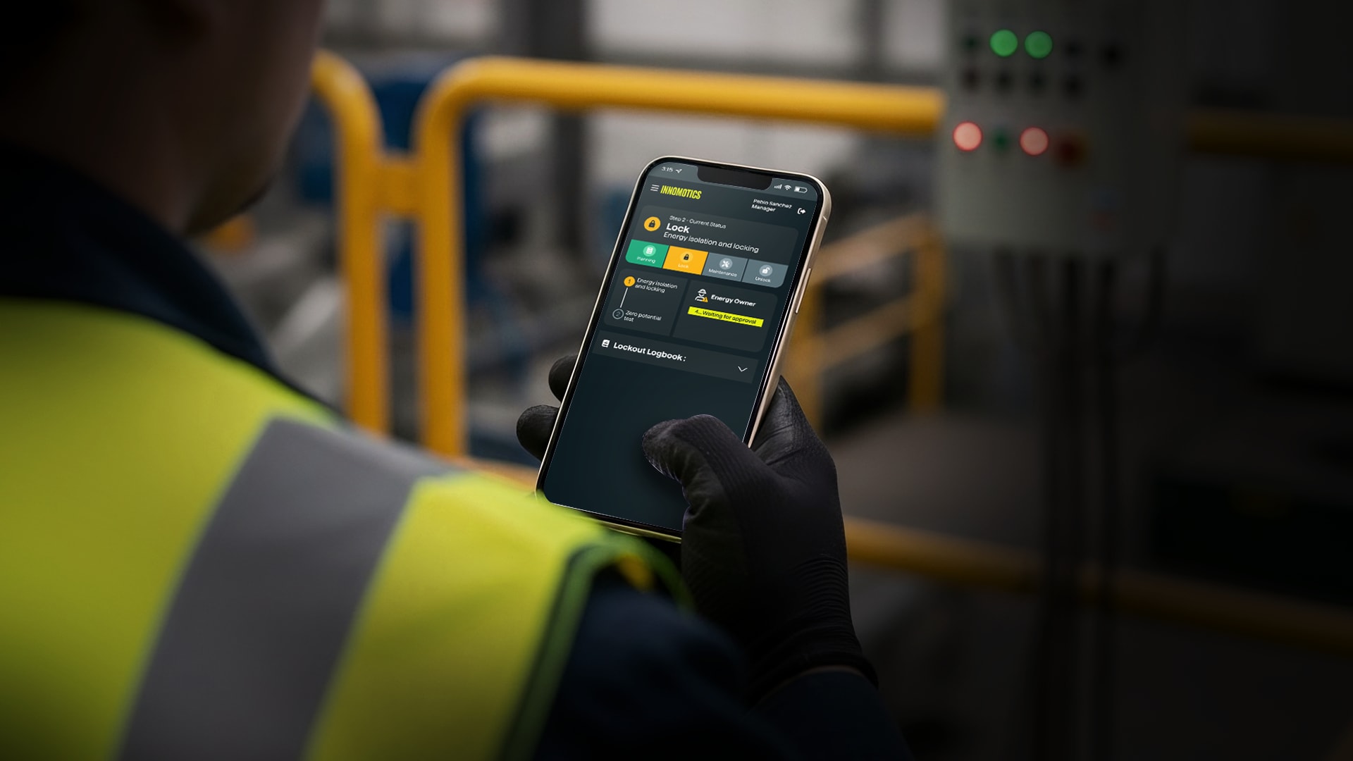 A man holding a smart phone with the Integrate Shield mobile app shown on screen.